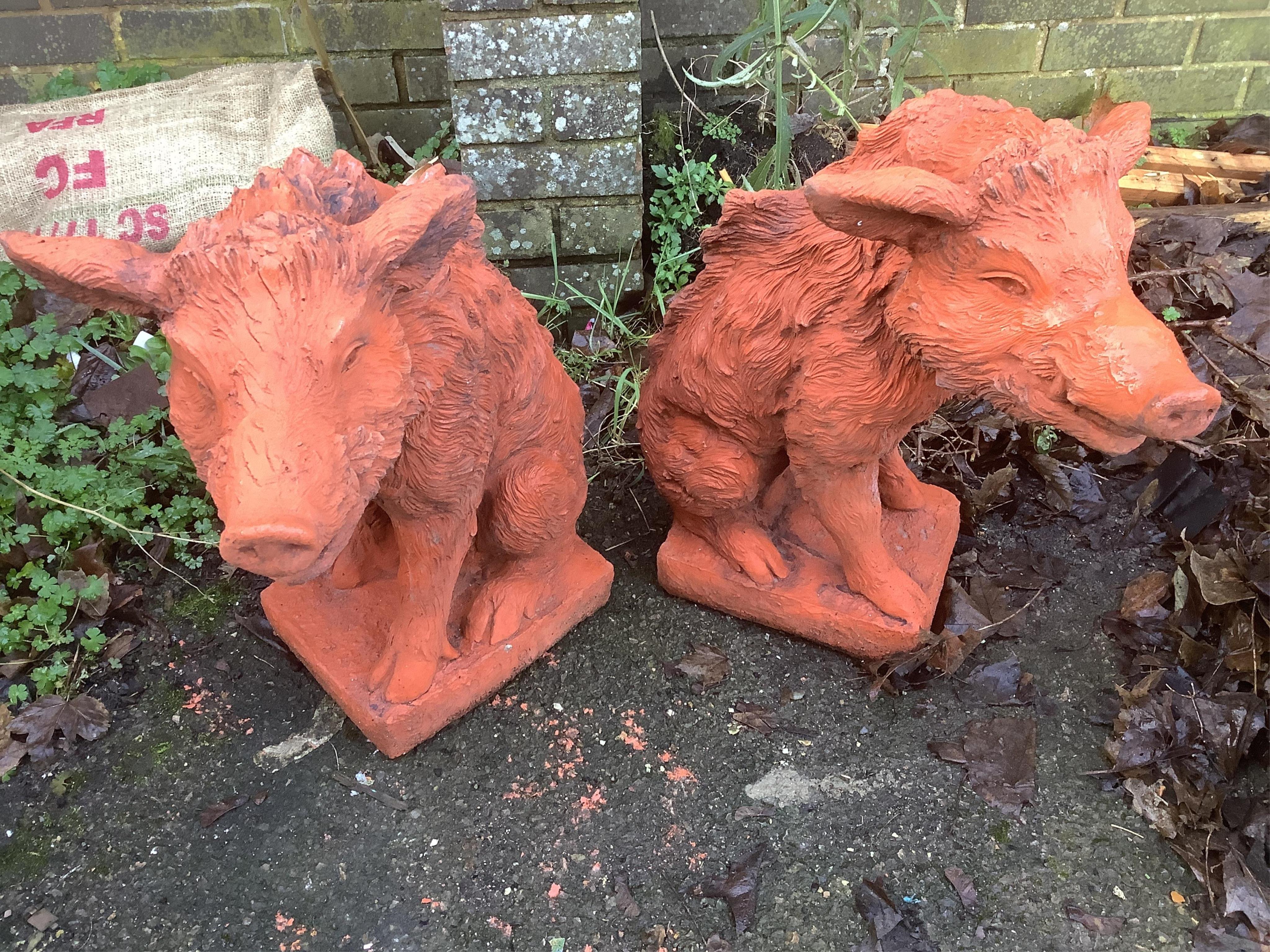 A pair of terracotta boars. Condition